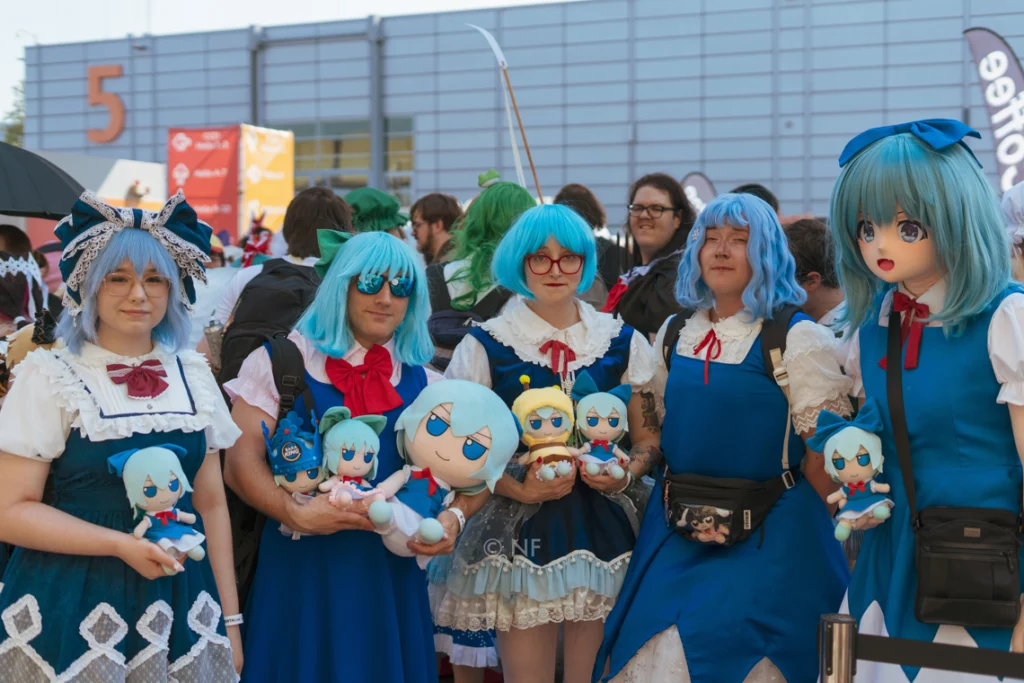Fünf Cosplayer mit unterschiedlichen Cirno-Outfits und zahlreichen Cirno-Fumos